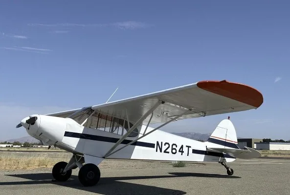 Marketing image of a 1953 Piper Super Cub PA-18.