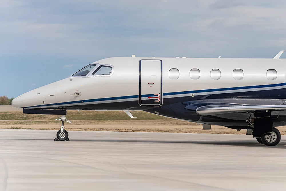 Exterior view of a 2024 Embraer Phenom 300E, N24PL.