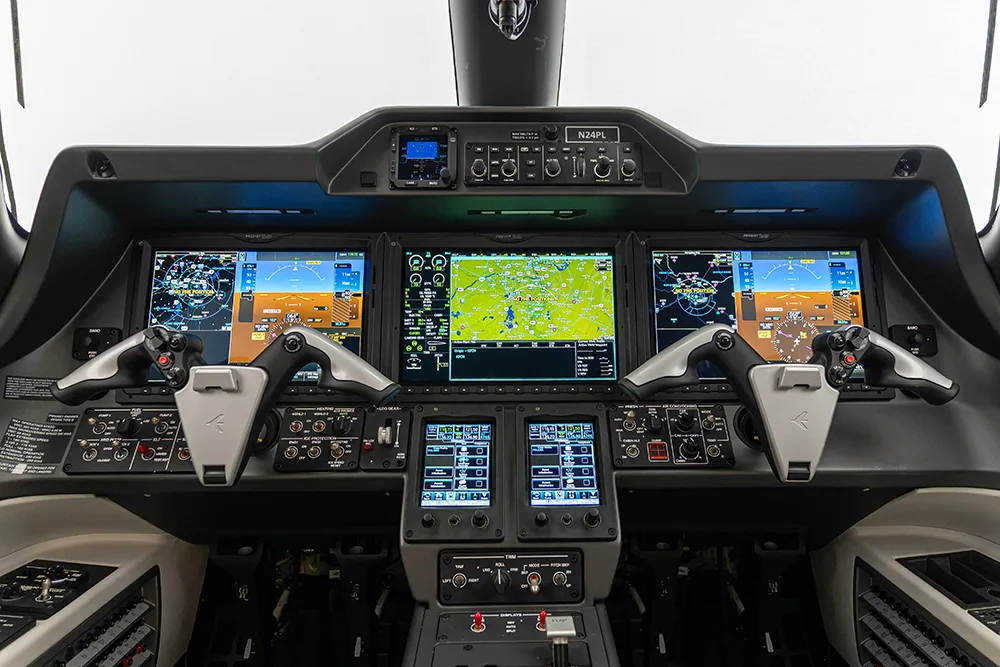 Cockpit and instrument panel of a 2024 Embraer Phenom 300E.