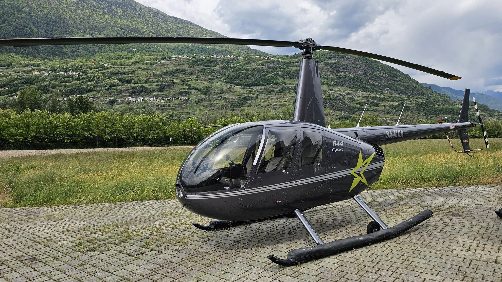 Exterior view of a 2009 Robinson R44 Clipper II, 3A-MCA.