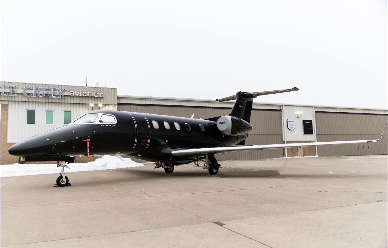 Exterior view of a 2012 Embraer Phenom, N506P.