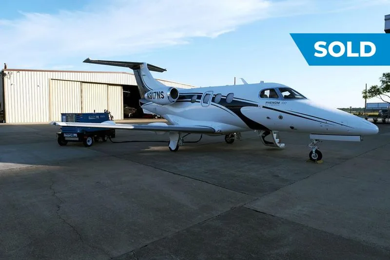 Exterior view of a 2011 Embraer Phenom 100, N917NS.
