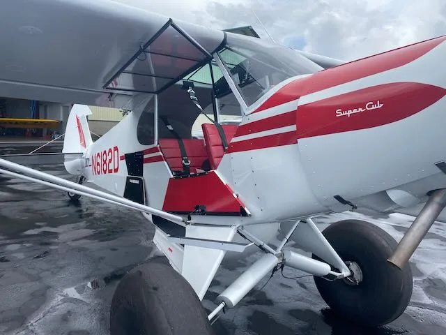 Exterior view of a 1957 Piper PA-18-150, N6182D.