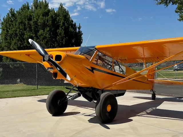 Exterior view of a 1979 Piper PA-18-150, N9166T.