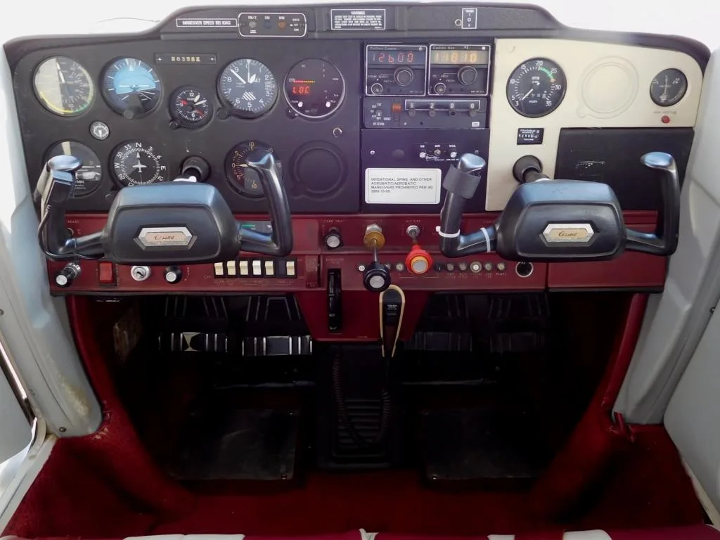 Cockpit and instrument panel of a 1976 Cessna 150M - N6355K Aircraft.