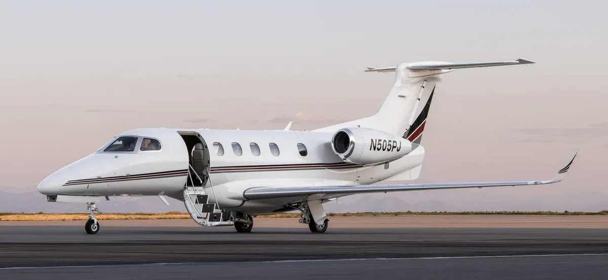 Exterior view of a 2013 Embraer Phenom 300 SN 50500165, N505PJ.