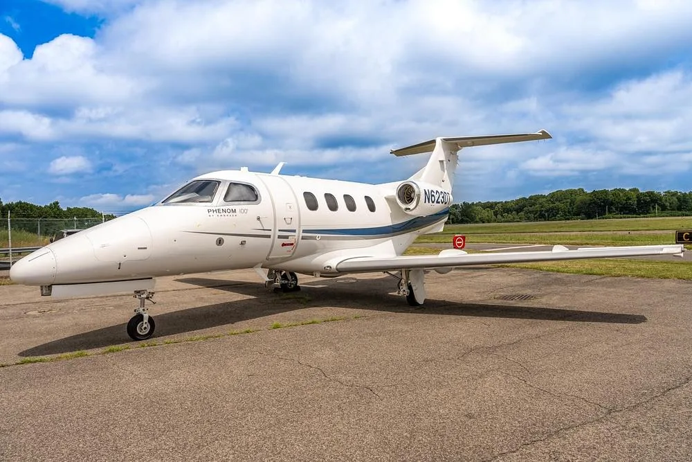 Exterior view of a 2010 Embraer Phenom 100, N623DT.