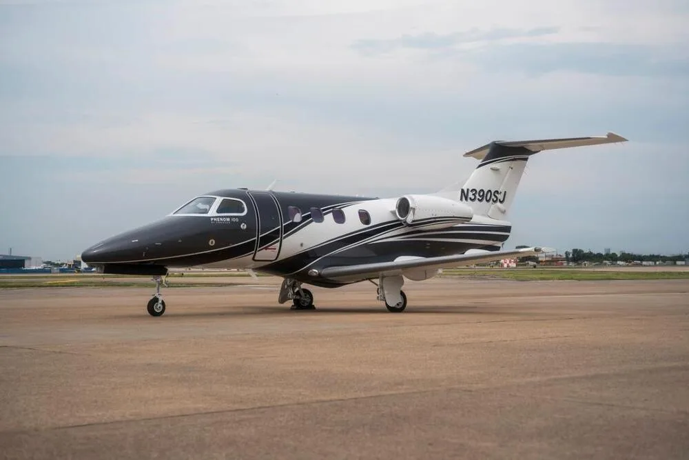 Exterior view of a 2010 Embraer Phenom 100, N390SJ.