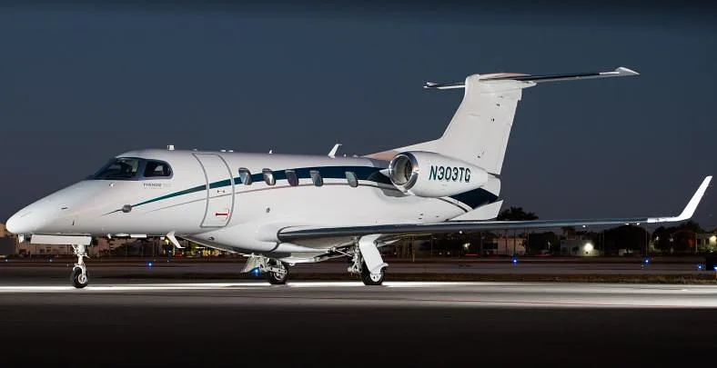 Exterior view of a 2020 Embraer Phenom 300E, N303TG.