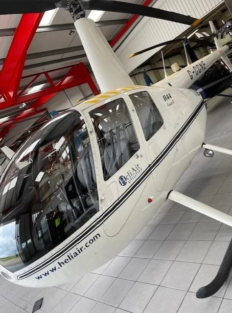Exterior view of a 2010 ROBINSON R44 RAVEN II, G-CGNE.