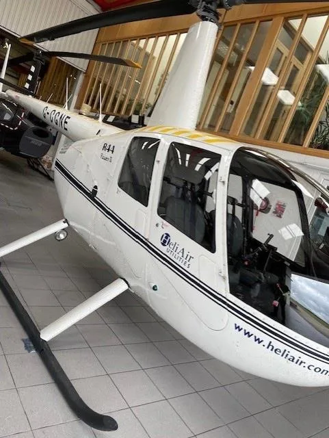 Exterior view of a 2010 ROBINSON R44 RAVEN II, G-CGNE.