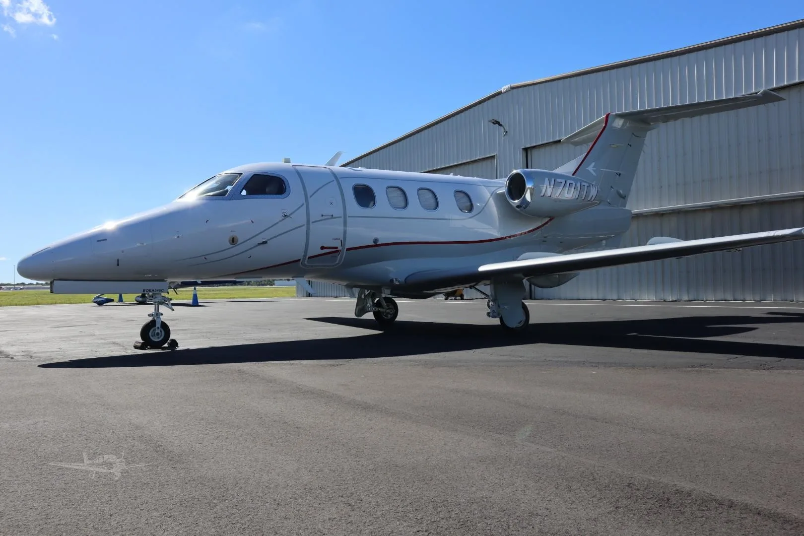 Exterior view of a 2009 EMBRAER PHENOM 100, N701TW.