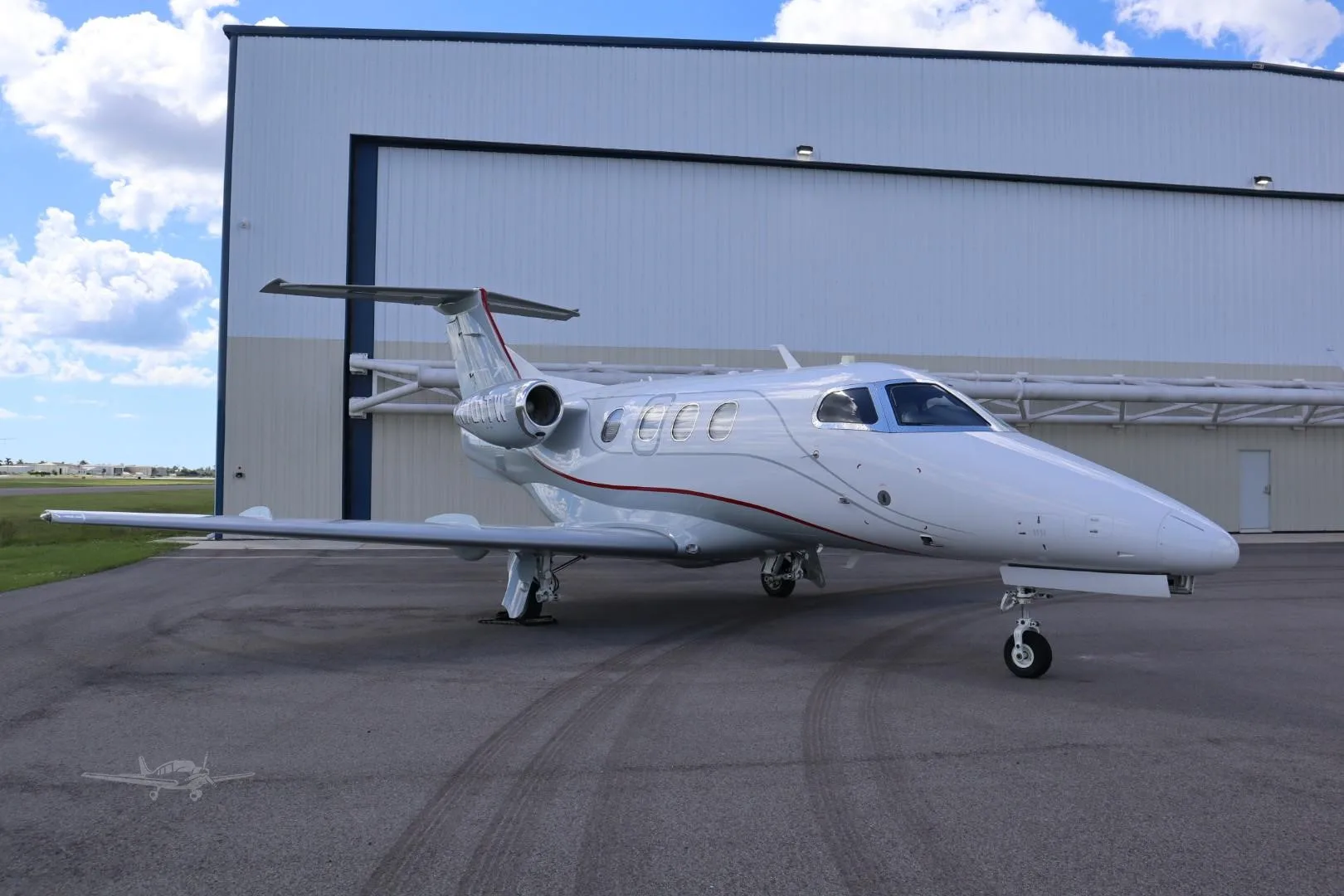 Exterior view of a 2009 EMBRAER PHENOM 100, N701TW.
