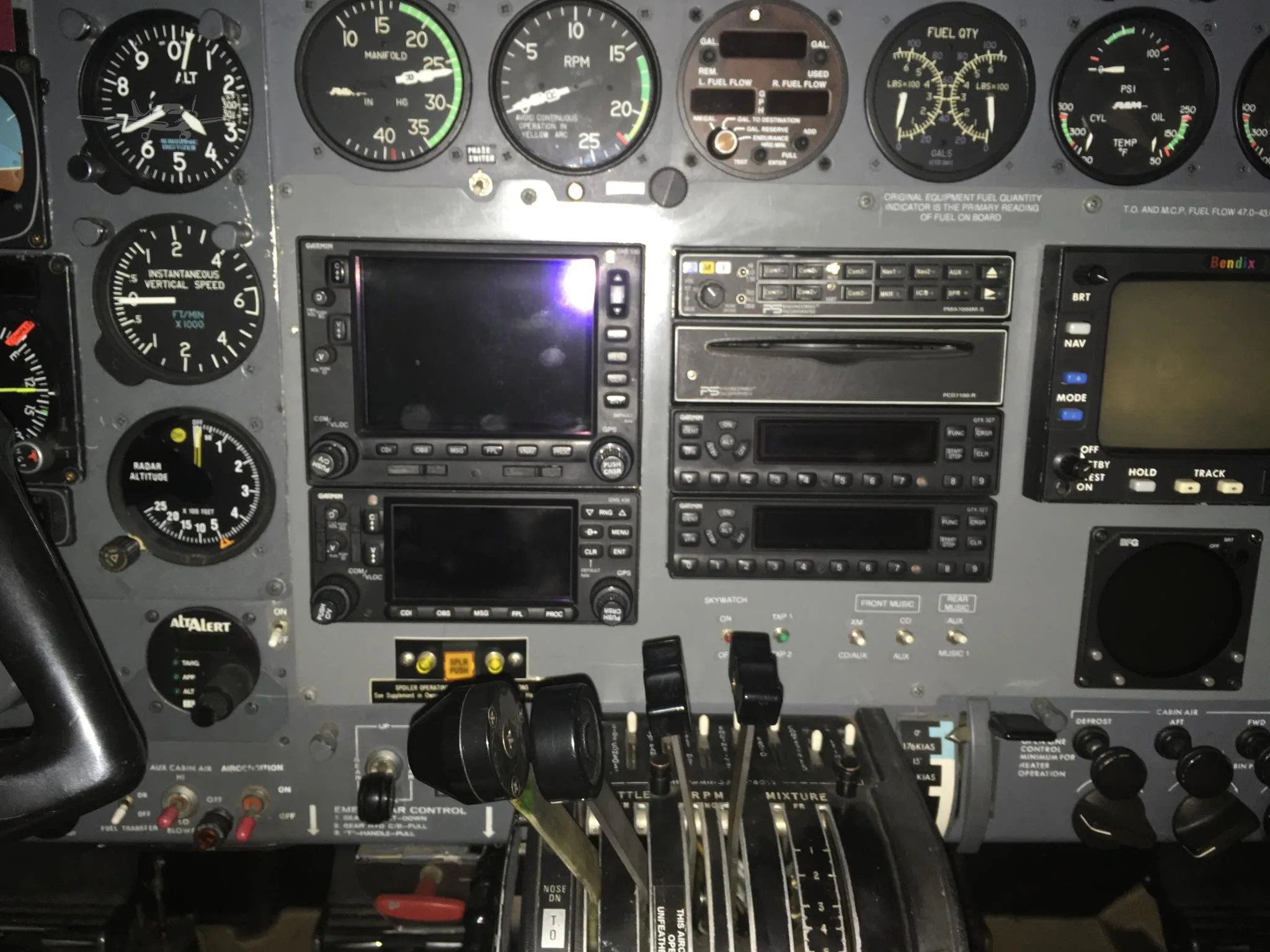 A detailed view of the aircraft's cockpit instrument panel, including navigation screens and engine controls.