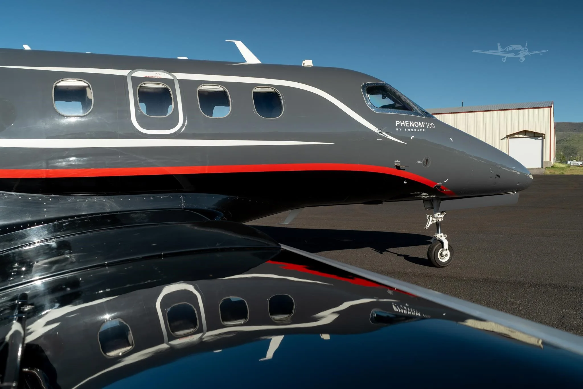 Exterior view of a 2013 EMBRAER PHENOM 100, N506B.
