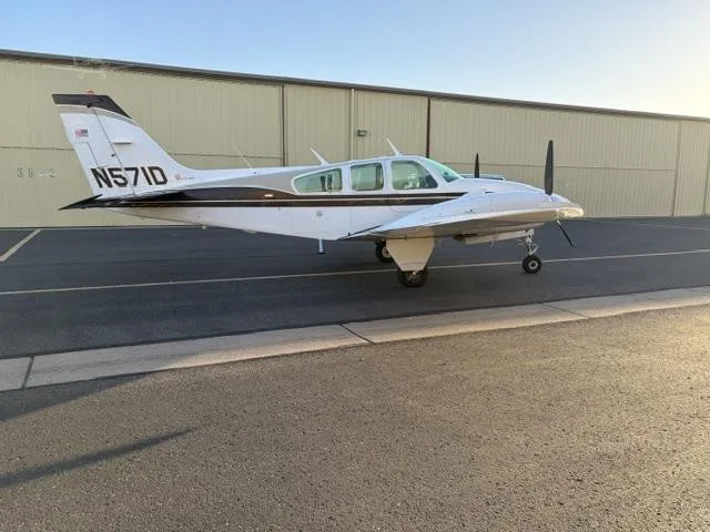 Exterior view of a 1975 BEECHCRAFT E55 BARON, N571D.
