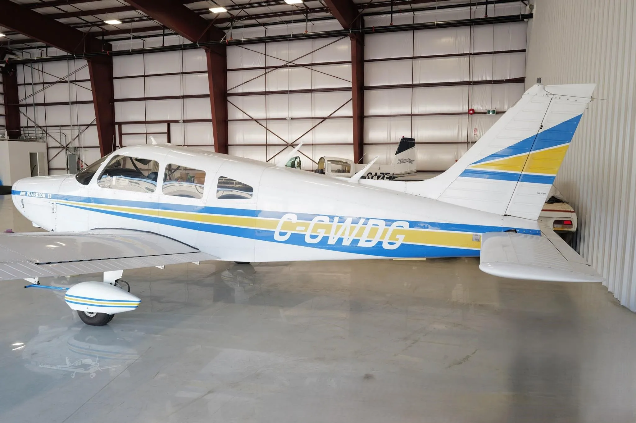 Exterior view of a 1977 PIPER WARRIOR II, C-GWDG.