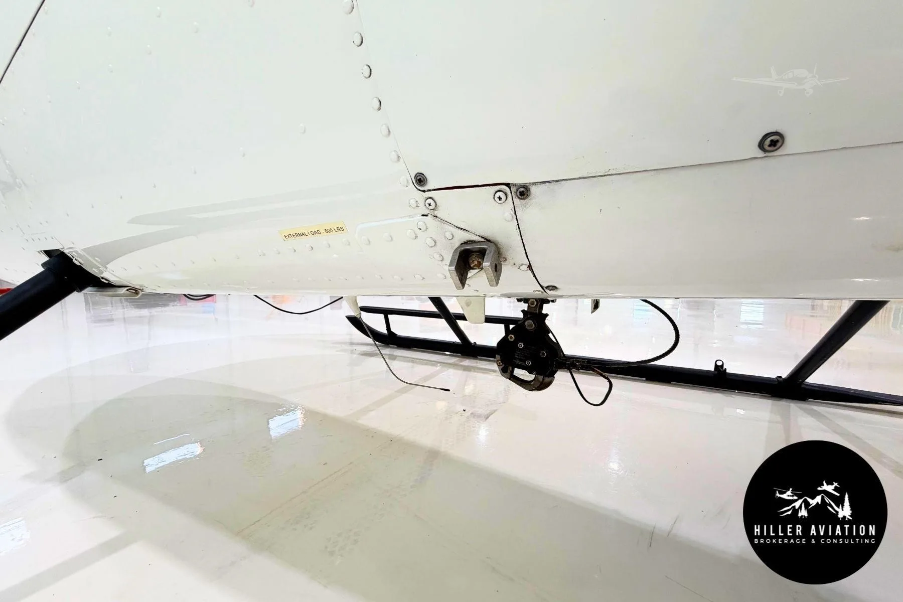 Exterior view of a 2006 ROBINSON R44 RAVEN II, N442WM.