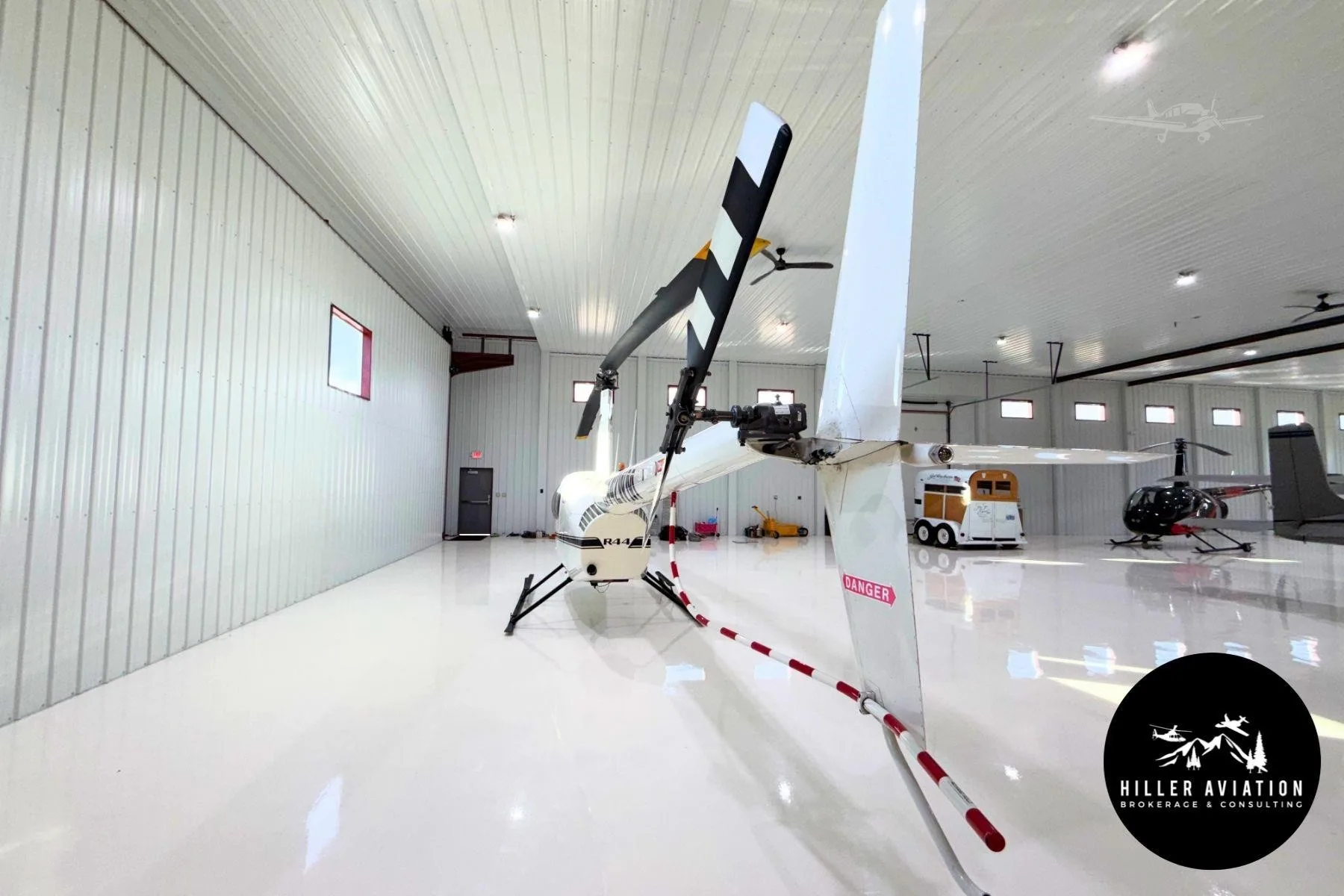 Exterior view of a 2006 ROBINSON R44 RAVEN II, N442WM.