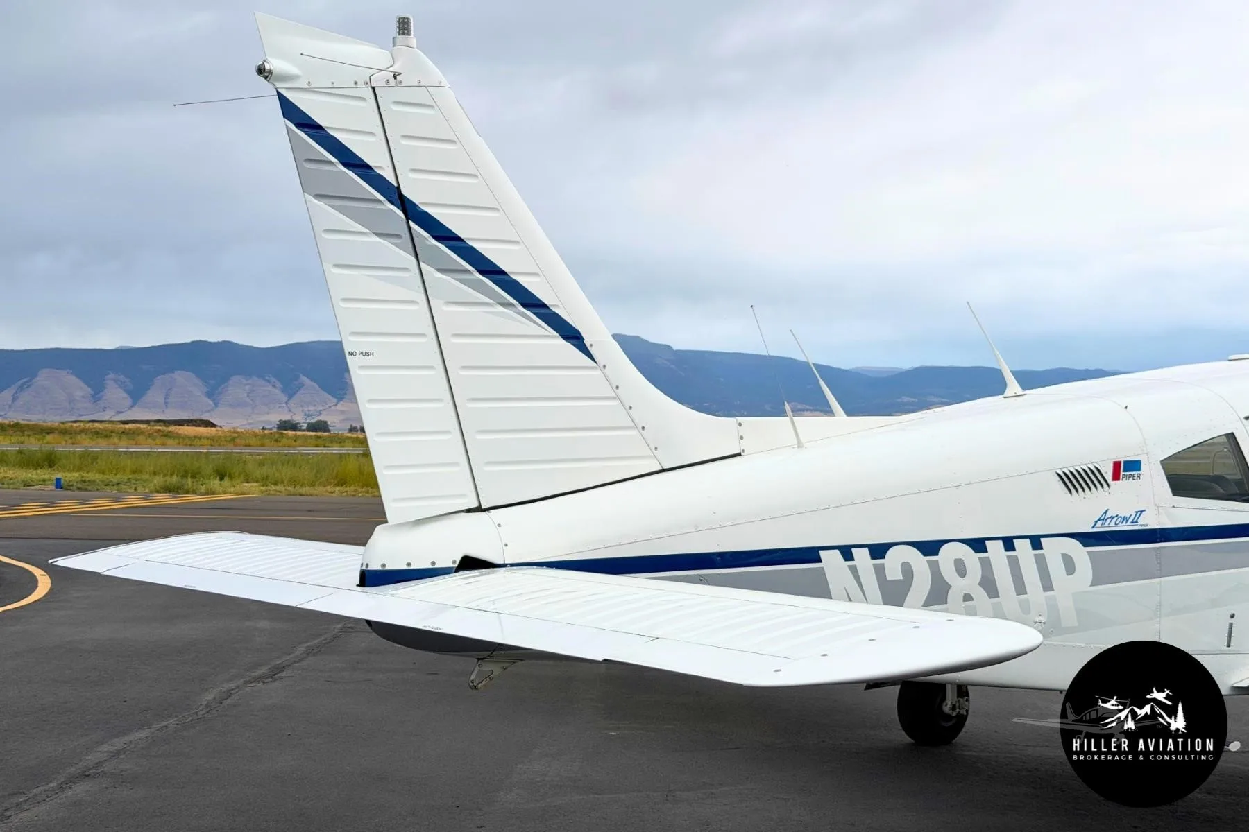Exterior view of a 1973 PIPER ARROW II, N28UP.