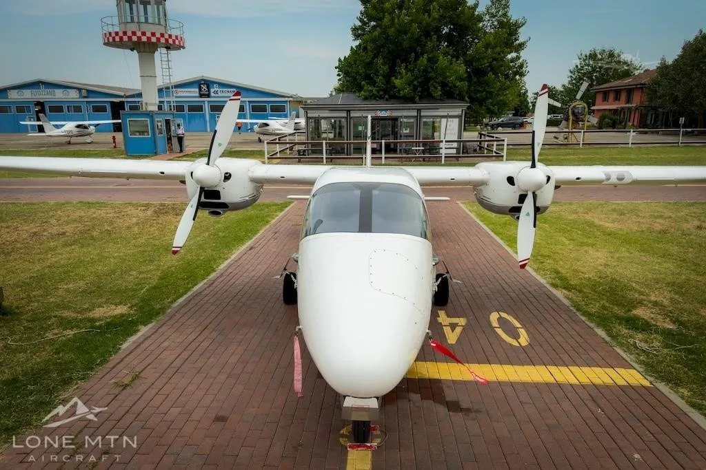 Exterior view of a 2017 TECNAM P2006T, I-OZZC.
